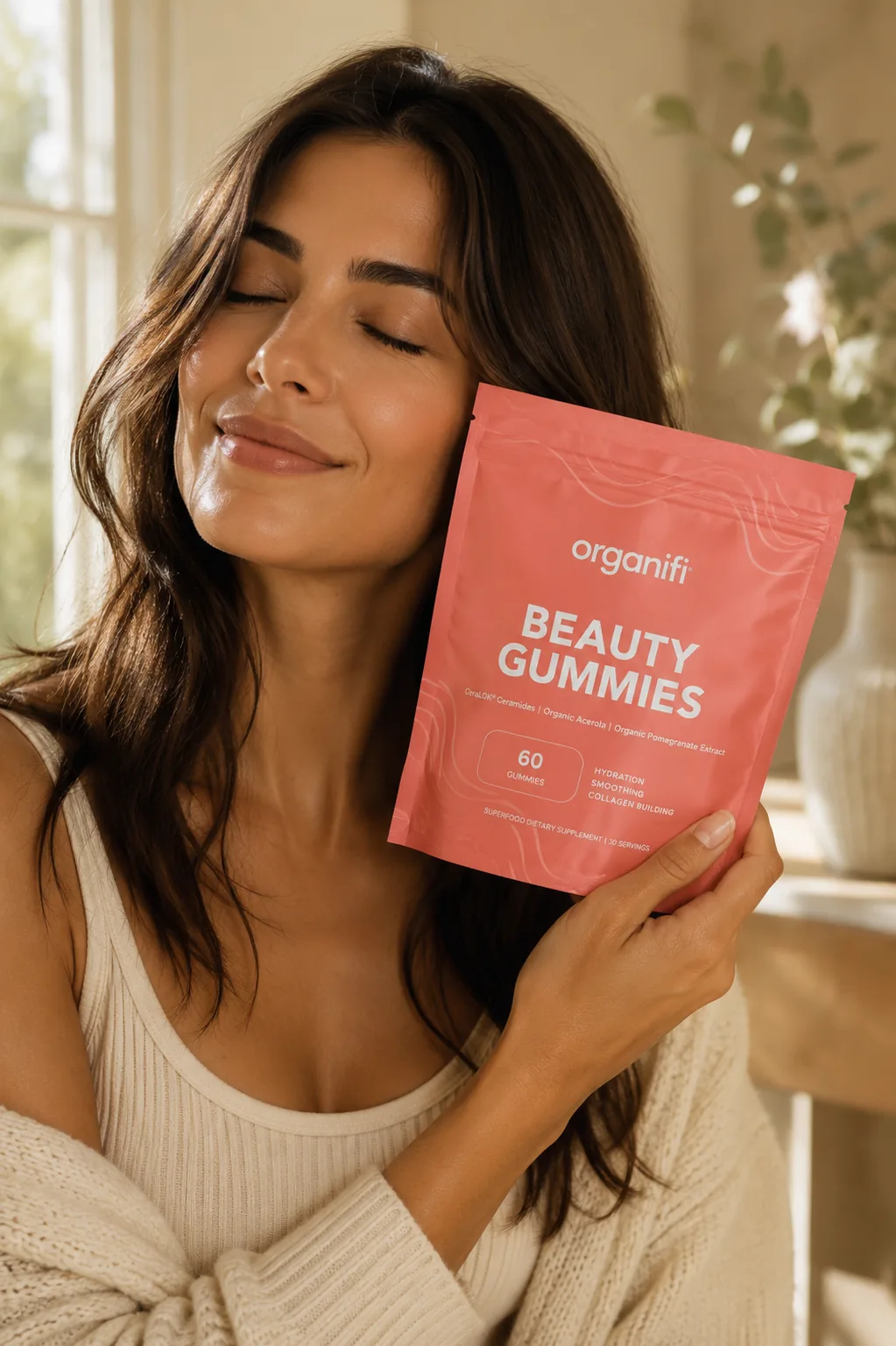 Woman holding Beauty Gummies pouch with healthy, radiant skin